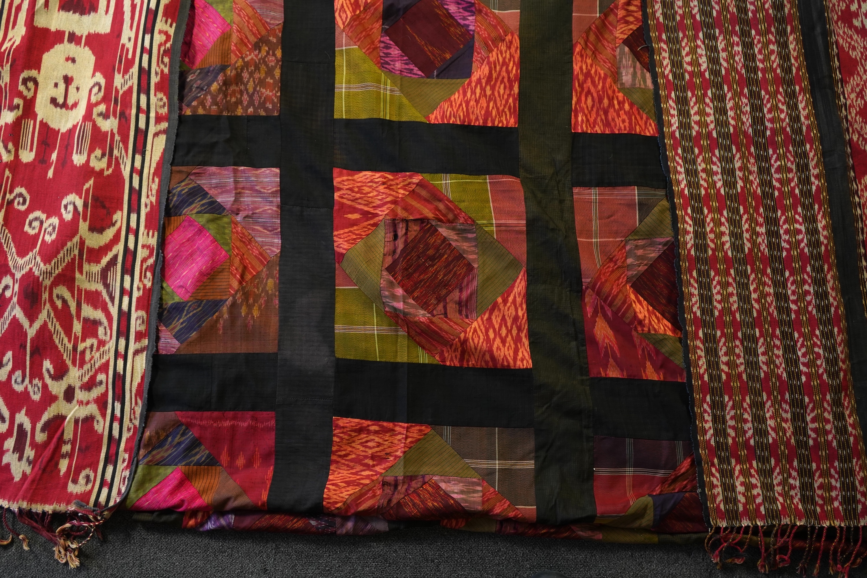 A 20th century Indonesian Sumba single Ikat shoulder cloth, a similar Celebes cloth, a Berber woven skirt and saddle bag and a patchwork cover. (5). Skirt 110cm including hessian top., Condition - some patchwork in the c